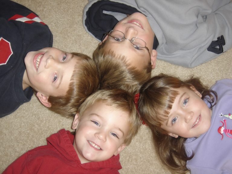 Kids Laying on the Floor with Their Heads Together